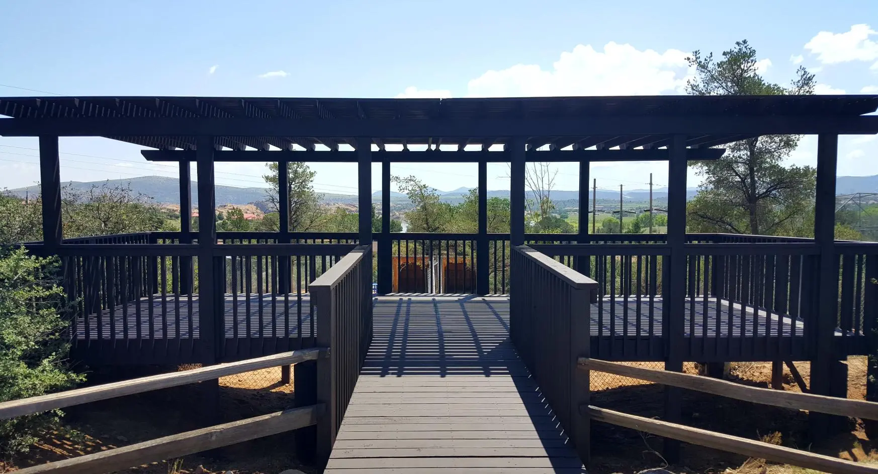A wooden walkway leading to a covered area